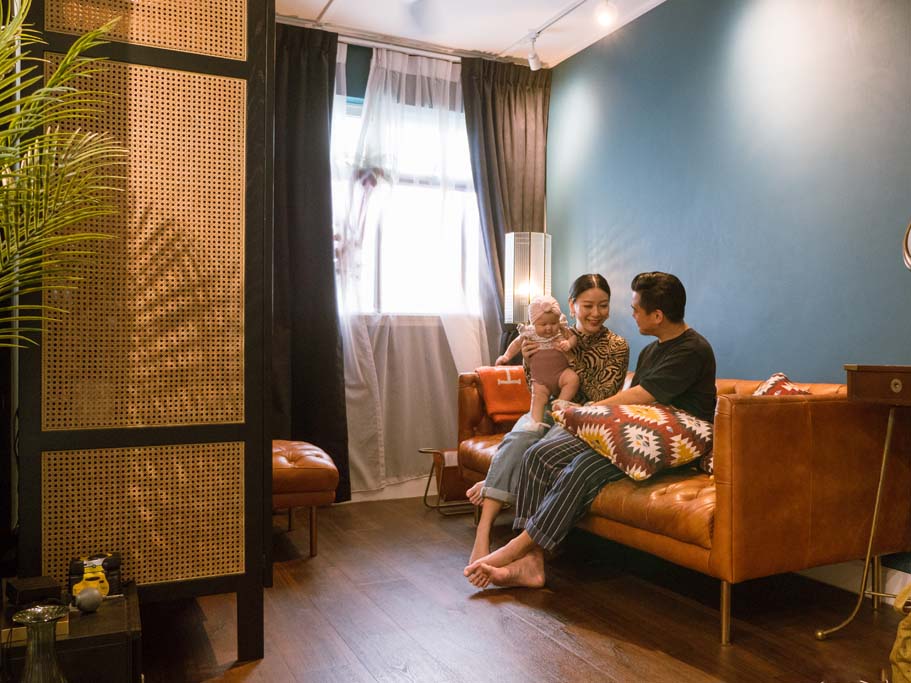 Kenneth and Xin Rong with their daughter on the sofa.