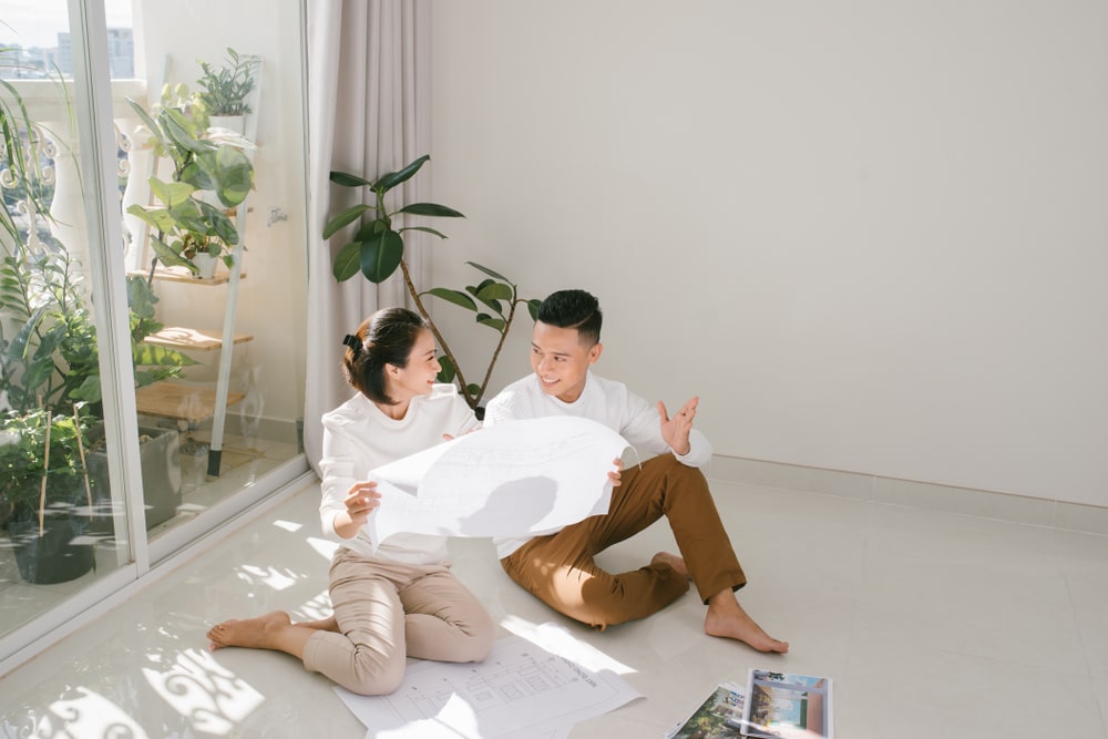 Photo of couple sitting on their living room floor