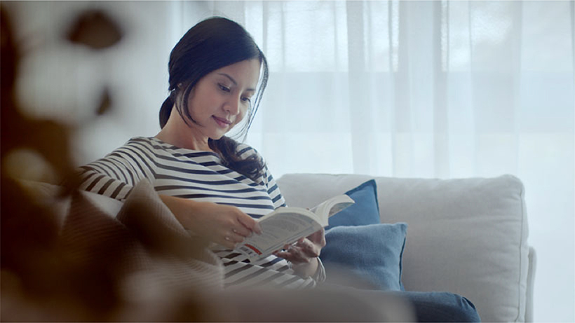 Photo of Nadia reading at home