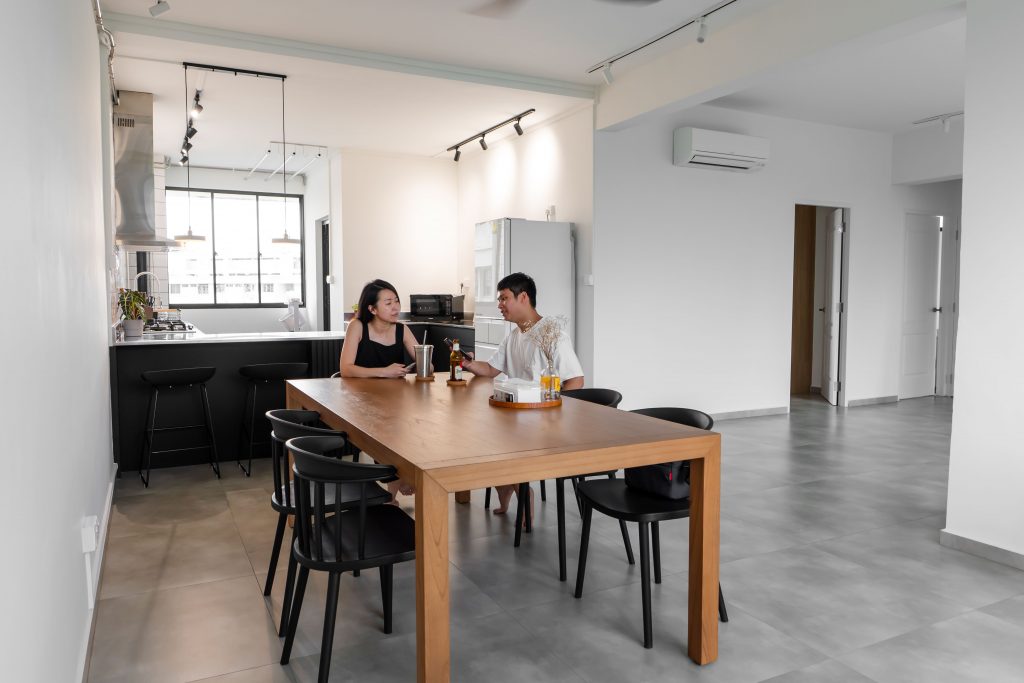 Home owners Shu Xia and Jin An at the dining table in their HDB flat